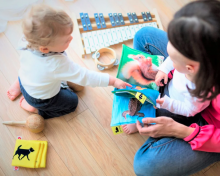 Baby, toddler and adult with books and xylophone