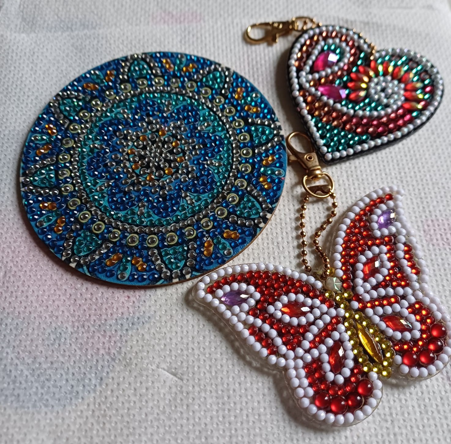 Bead creations of circle, heart and butterfly shapes made into keyrings