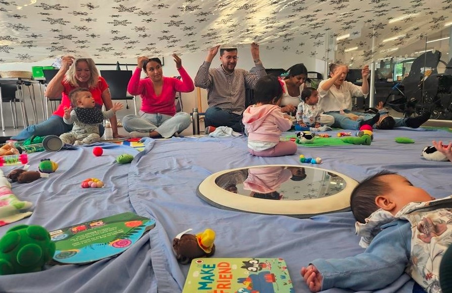 Adults with babies engaged in a range of multi-sensory activities