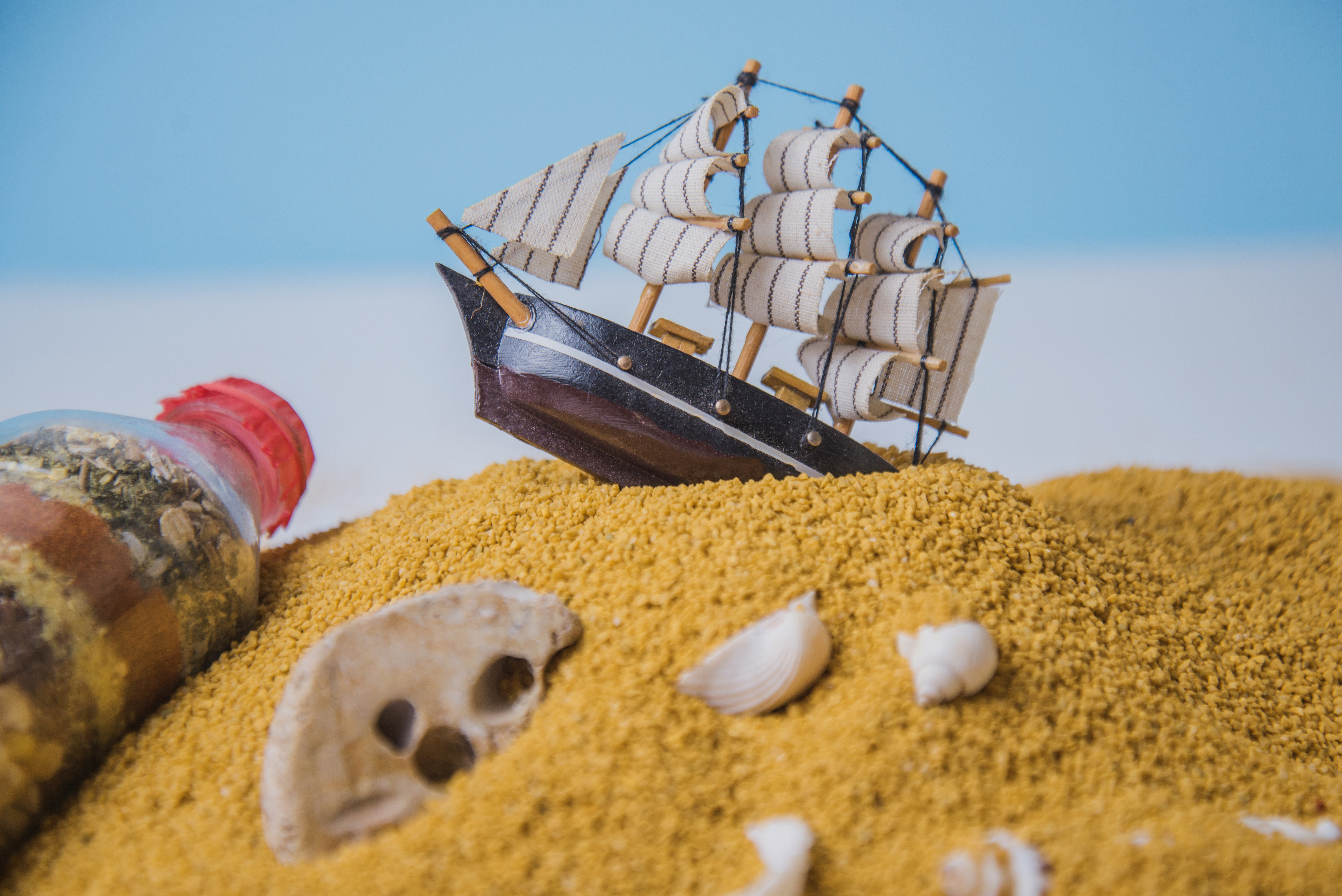 beach sand with a model ship