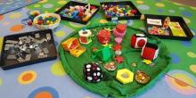 Floor mats and trays filled with toys for baby play