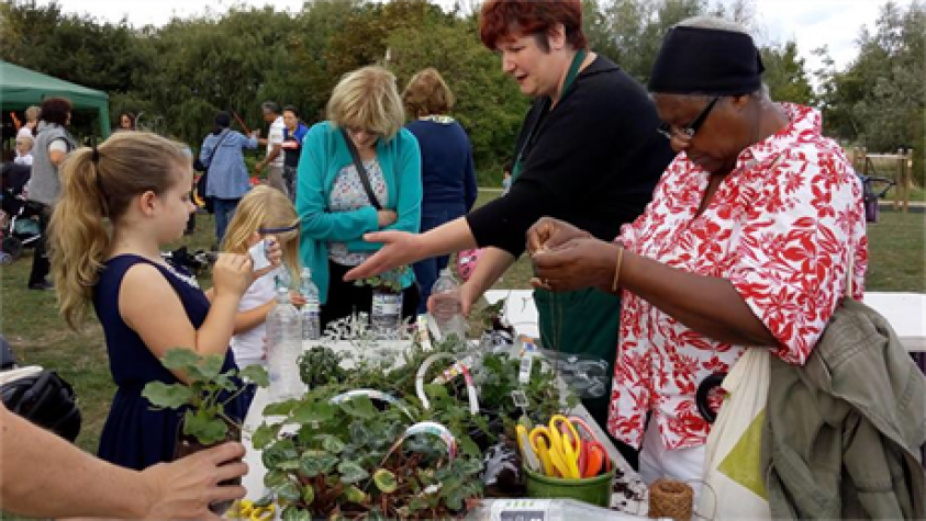 People gathered around a vegetable stand