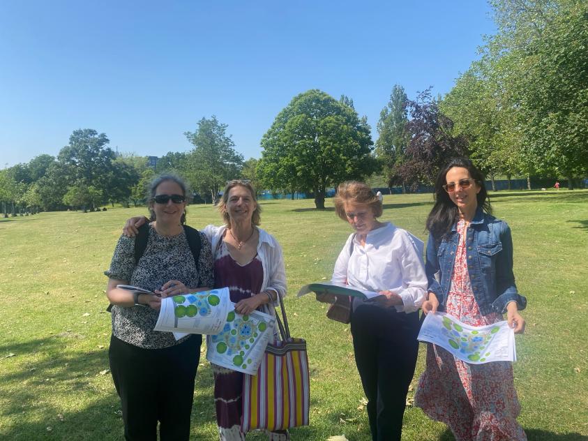 Key stakeholders examine the plans for the new Fair Play Barnet playground at the spot where it will be built.