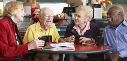 Group of older adults seated around a table